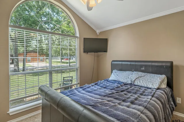 a bedroom with a large bed and a window