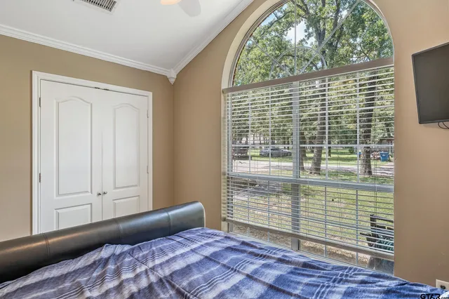 a bedroom with a bed and a window