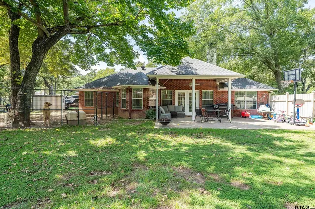 a backyard of a house with table and chairs