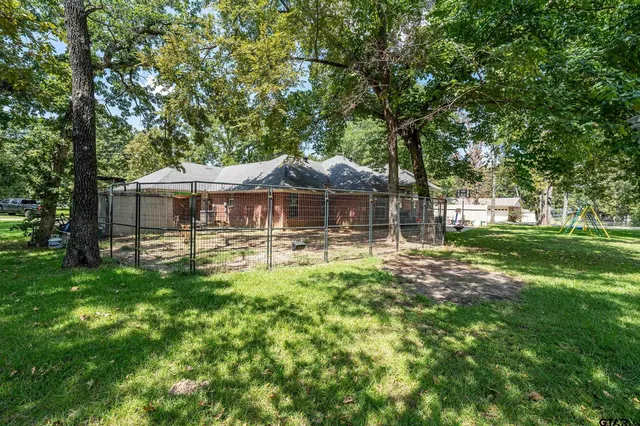 a front view of a house with yard patio and green space