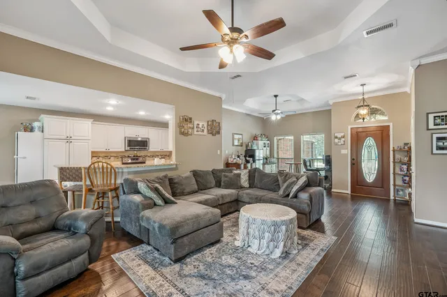 a living room with furniture and a chandelier
