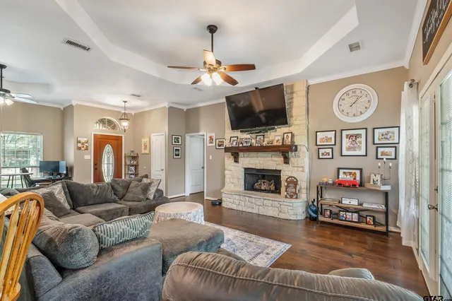 a living room with furniture a flat screen tv and a fireplace