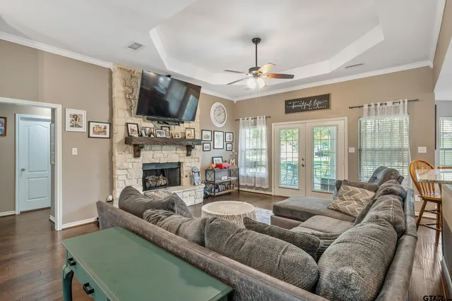 a living room with furniture a flat screen tv and a fireplace