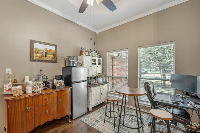 a view of a workspace with furniture and a window