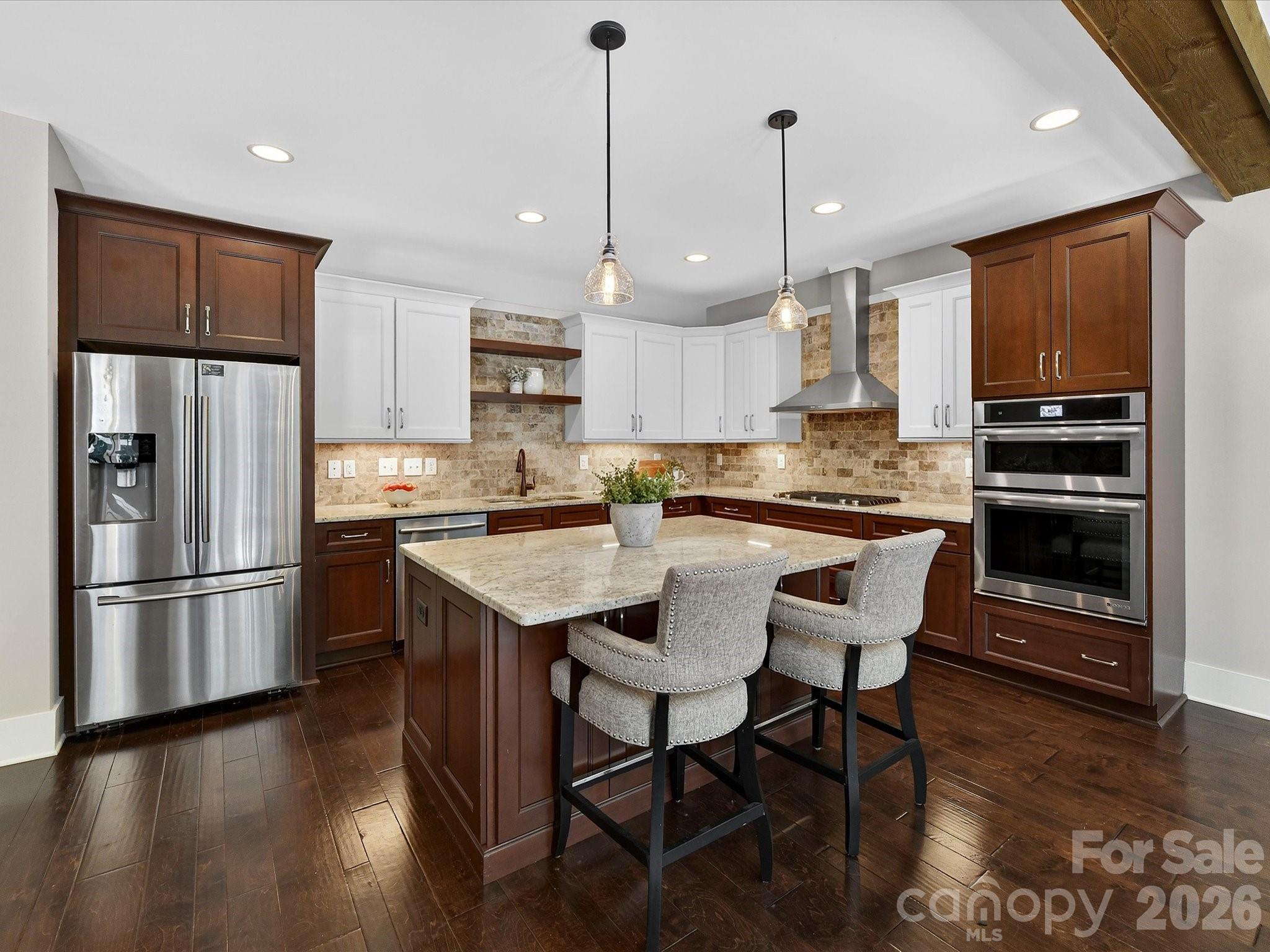 205 Streamwood Road Troutman, NC 28166 - Photo 13 of 41 a kitchen with stainless steel appliances granite countertop a refrigerator a stove a sink a dining table and chairs with wooden floor
