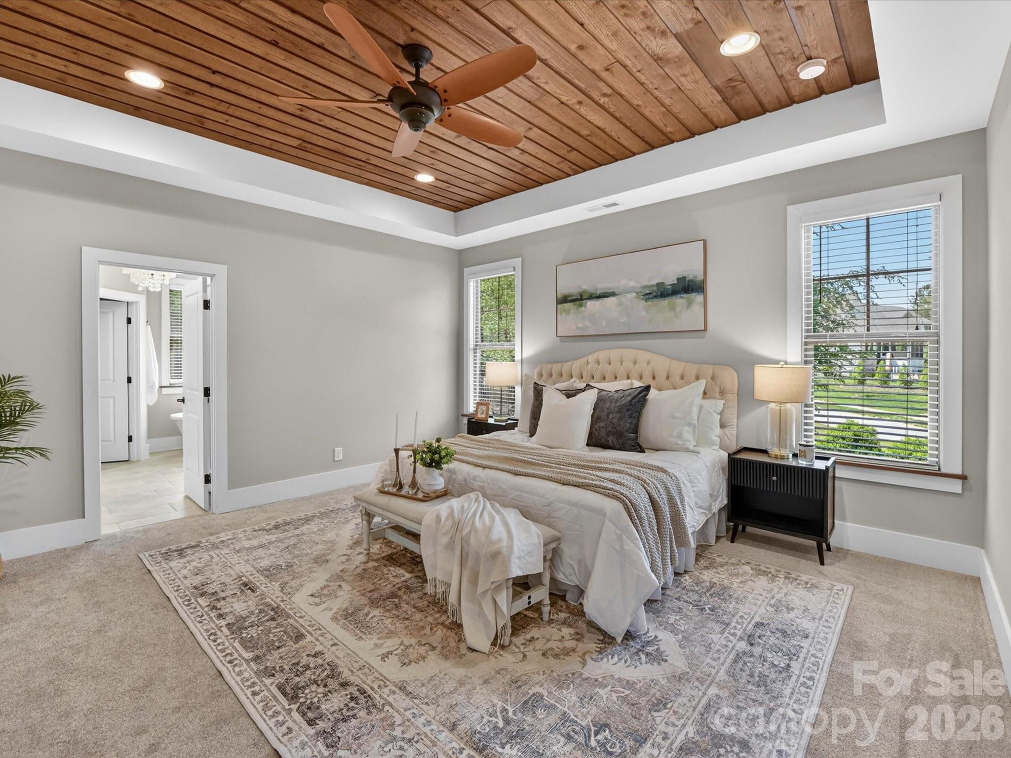 205 Streamwood Road Troutman, NC 28166 - Photo 19 of 41 a spacious bedroom with a large bed a chandelier and closet