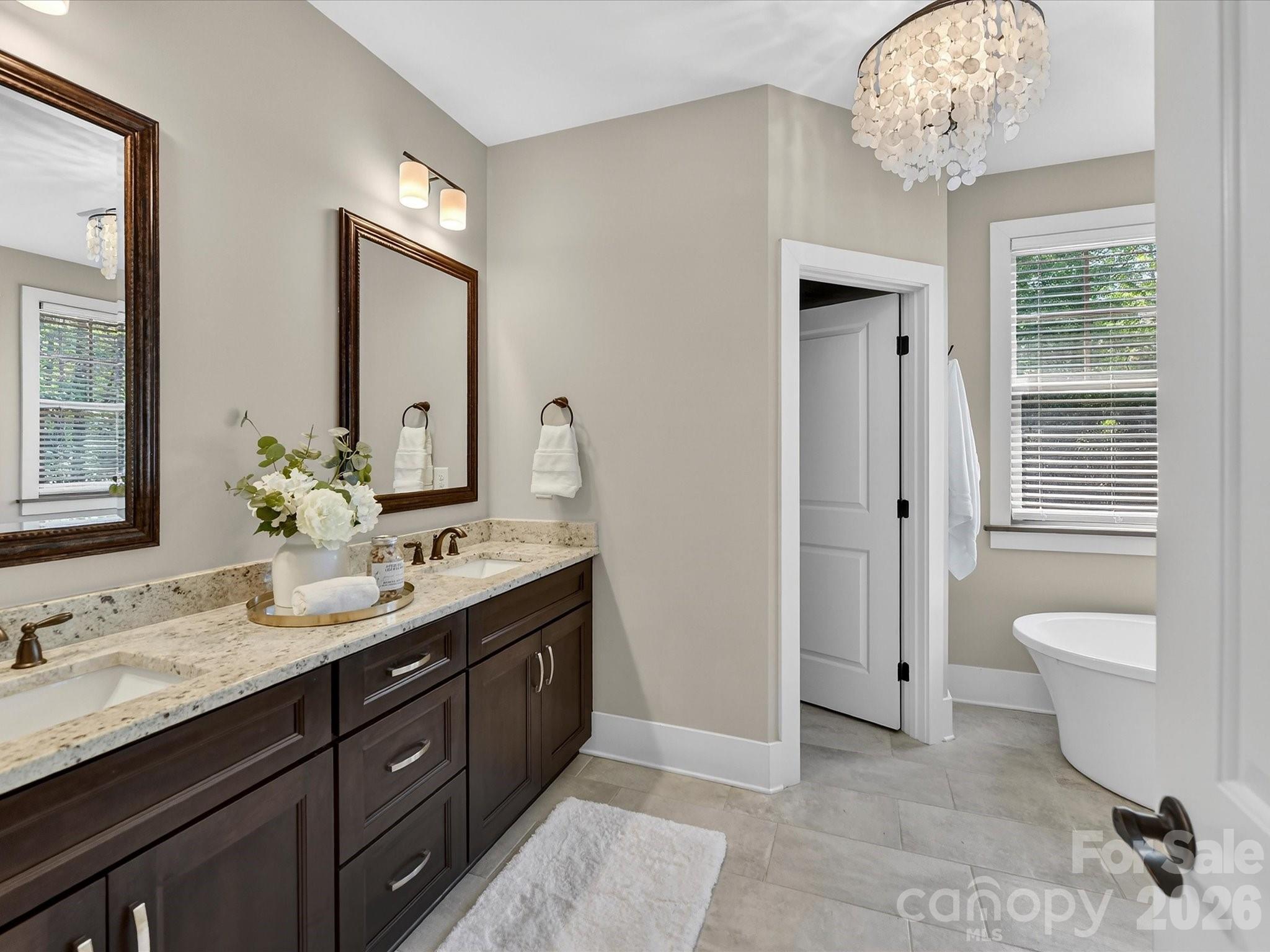 205 Streamwood Road Troutman, NC 28166 - Photo 21 of 41 a spacious bathroom with a double vanity sink a large mirror and a toilet