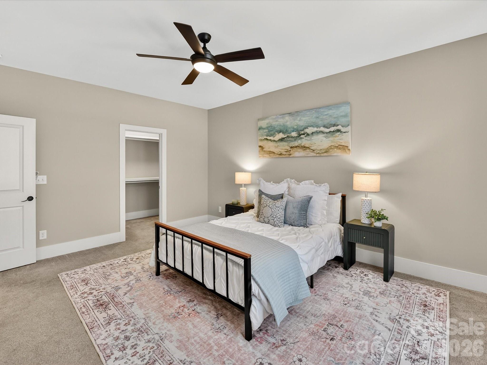 205 Streamwood Road Troutman, NC 28166 - Photo 24 of 41 a bedroom with a bed and a chandelier