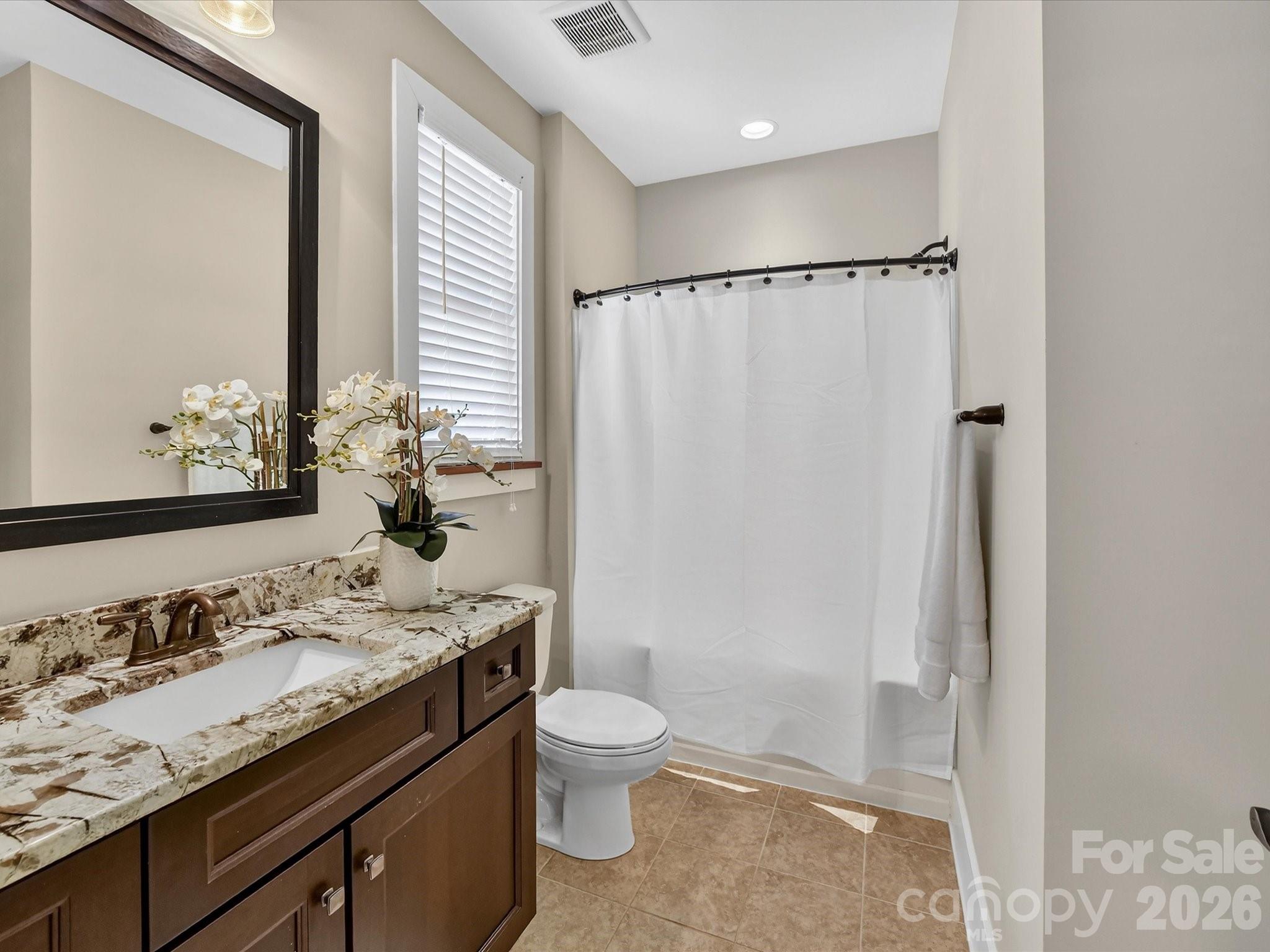 205 Streamwood Road Troutman, NC 28166 - Photo 26 of 41 a bathroom with a granite countertop sink toilet and shower