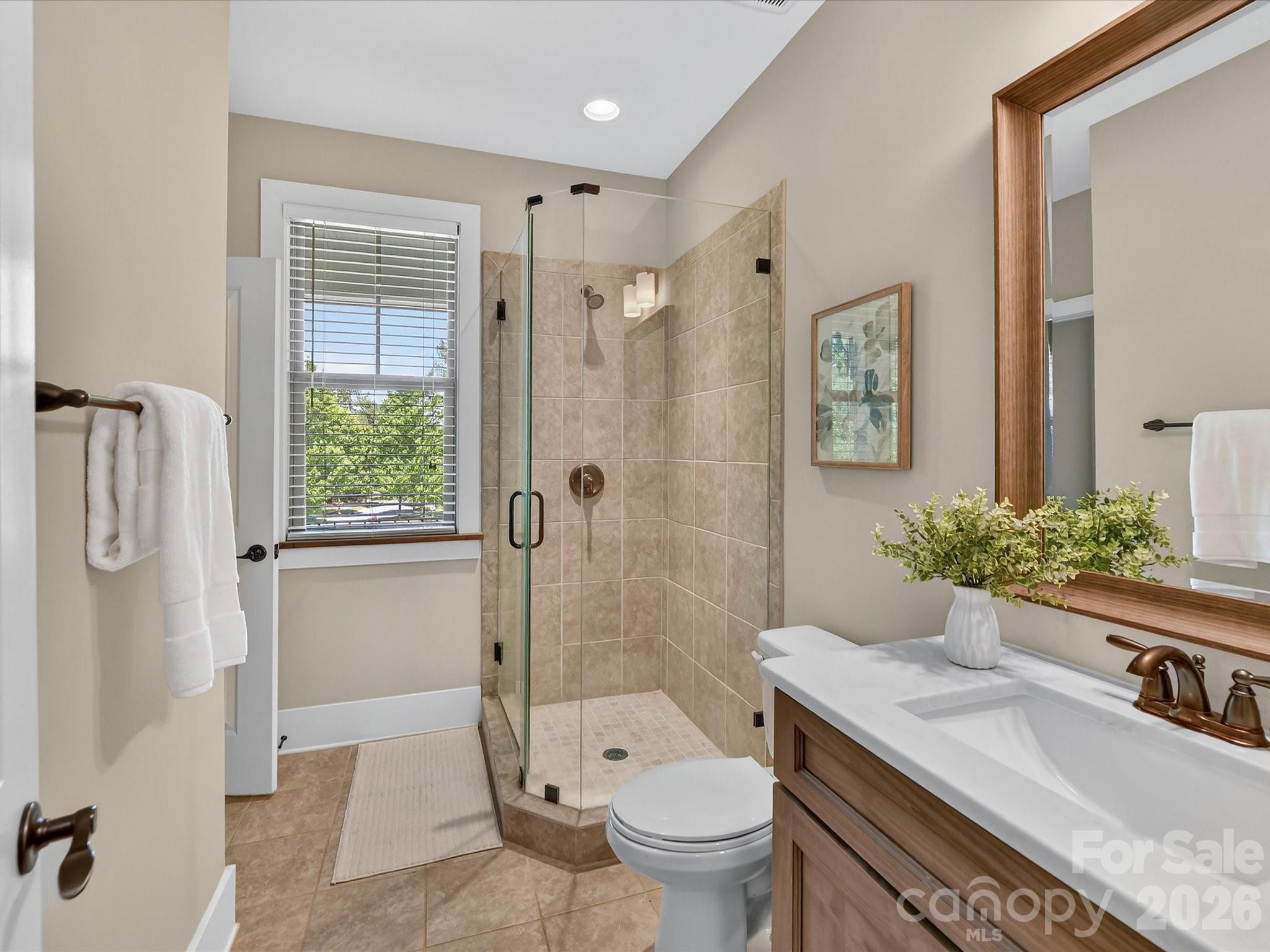 205 Streamwood Road Troutman, NC 28166 - Photo 28 of 41 a bathroom with a granite countertop sink toilet and shower