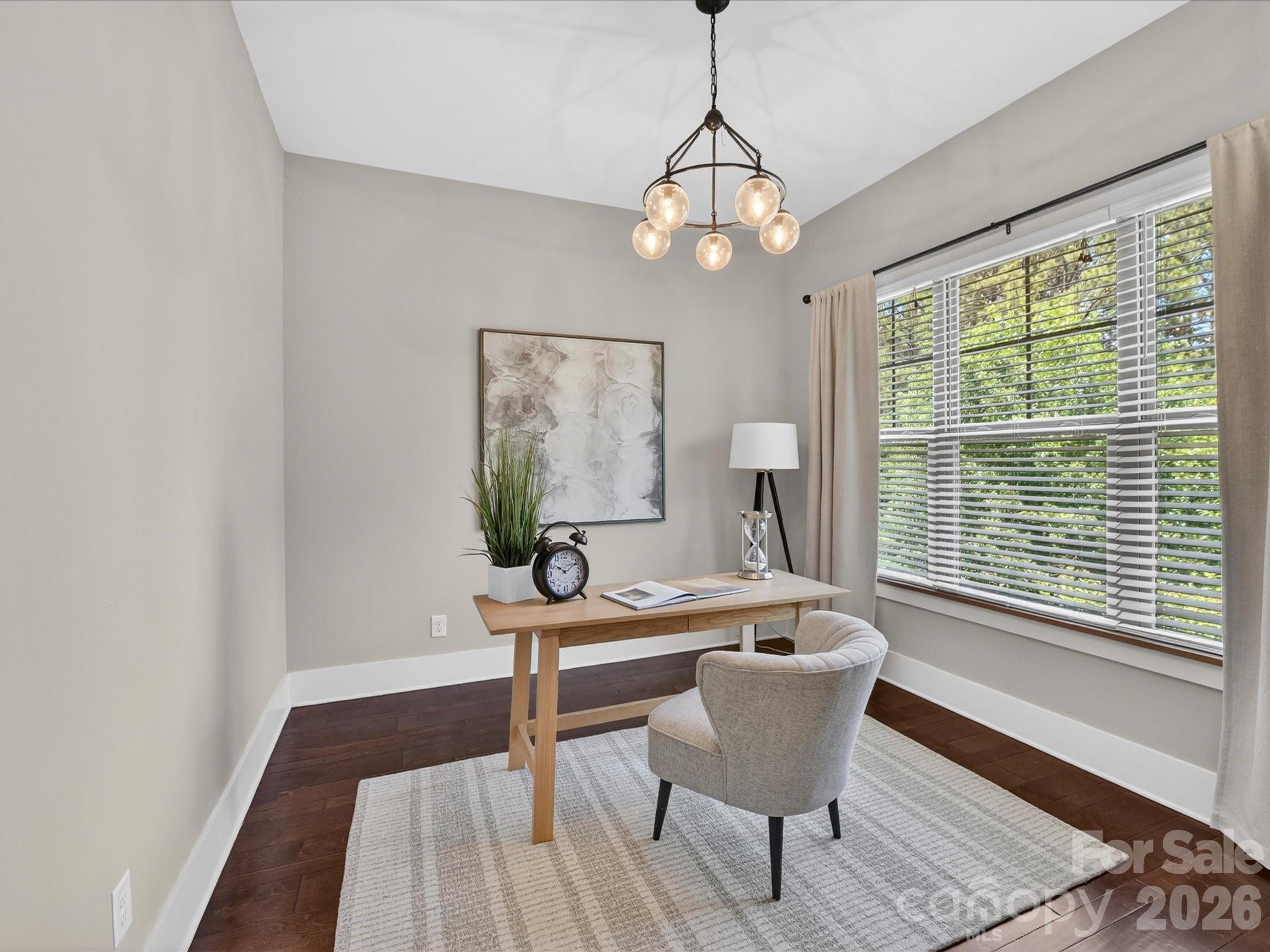 205 Streamwood Road Troutman, NC 28166 - Photo 8 of 41 a dining room with wooden floor and a chandelier