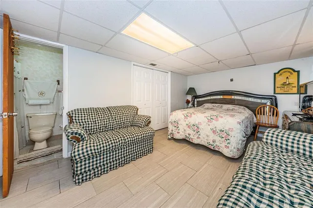 a bedroom with a bed and painting on the wall