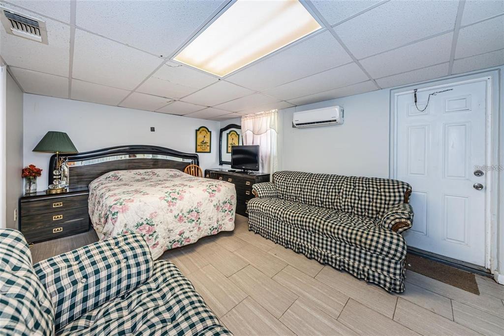 4902 Vision Avenue Holiday, FL 34690 - Photo 18 of 25 a bedroom with a bed and wooden floor