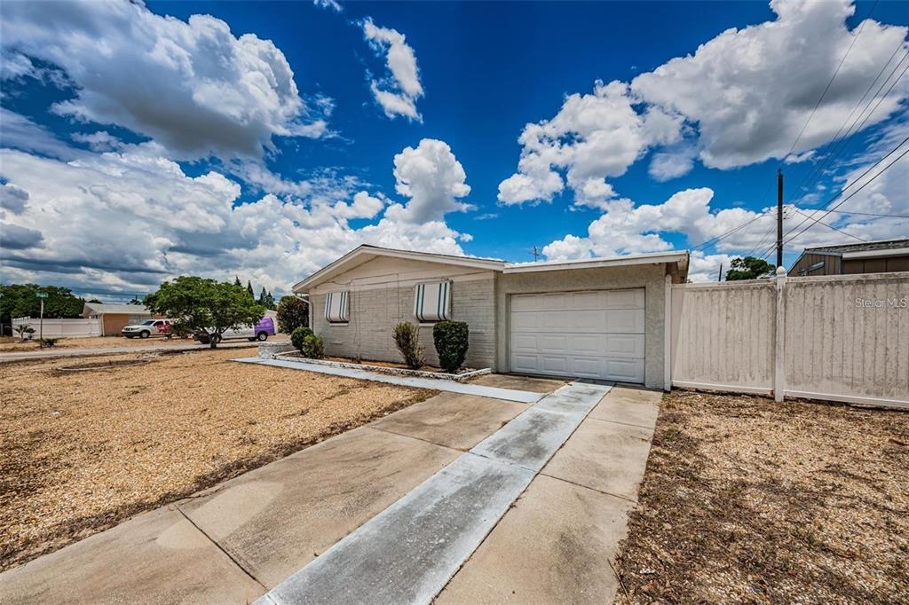 4902 Vision Avenue Holiday, FL 34690 - Photo 23 of 25 a view of a house with a yard