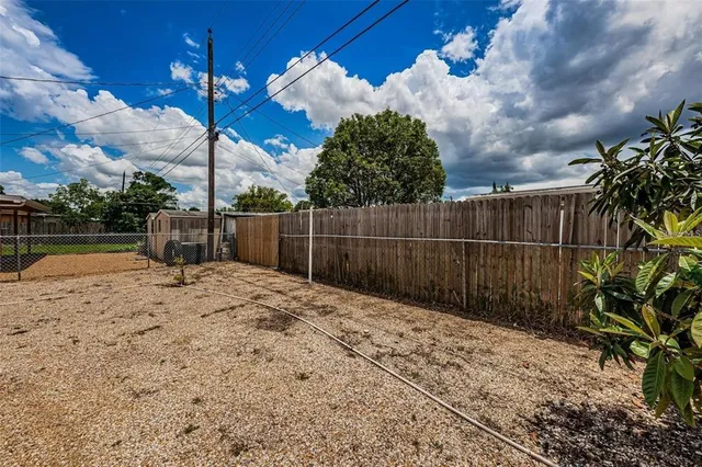 a view of a backyard with a tree