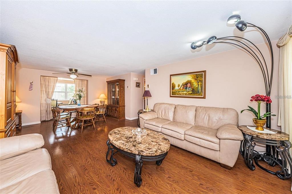 4902 Vision Avenue Holiday, FL 34690 - Photo 5 of 25 a living room with furniture and wooden floor