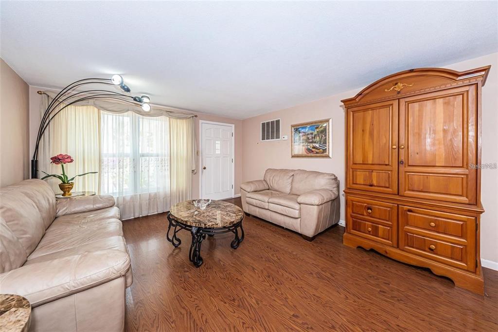 4902 Vision Avenue Holiday, FL 34690 - Photo 7 of 25 a living room with furniture and a window