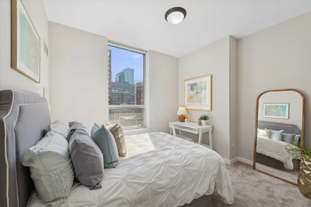 a bedroom with a bed and a mirror