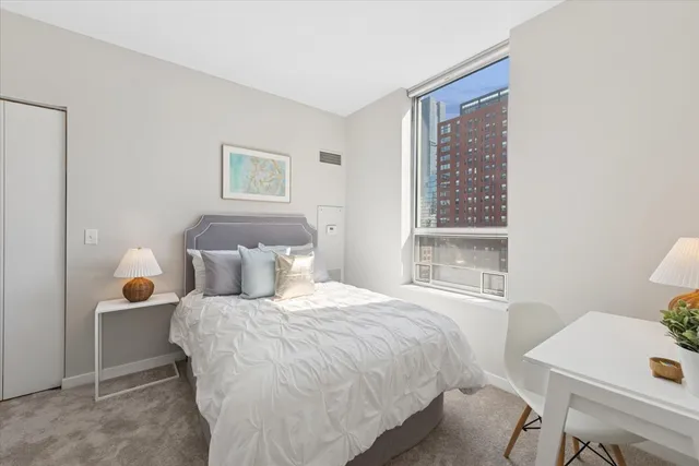 a bedroom with a bed and a window