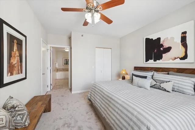 a bedroom with a bed and ceiling fan