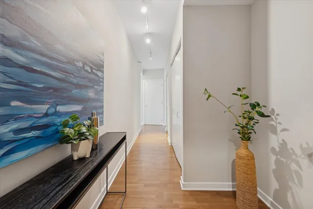 a hallway with flowers and wooden floor