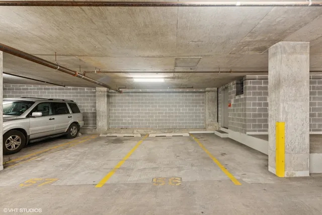 a view of parking garage with cars parked