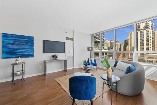 a living room with furniture a rug and a flat screen tv
