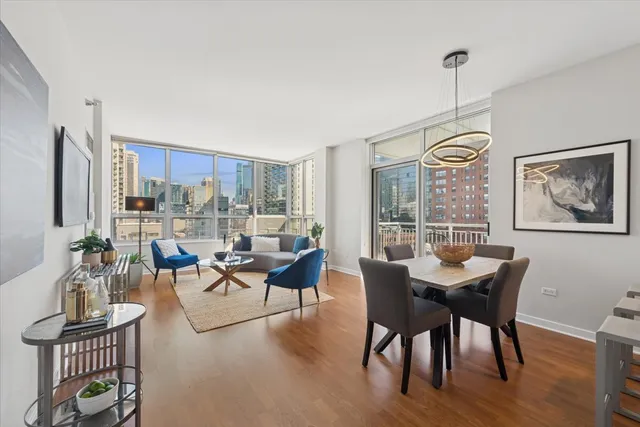 a living room with fireplace furniture and a large window