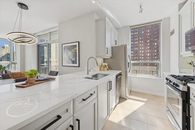 a kitchen with stainless steel appliances a sink stove and cabinets