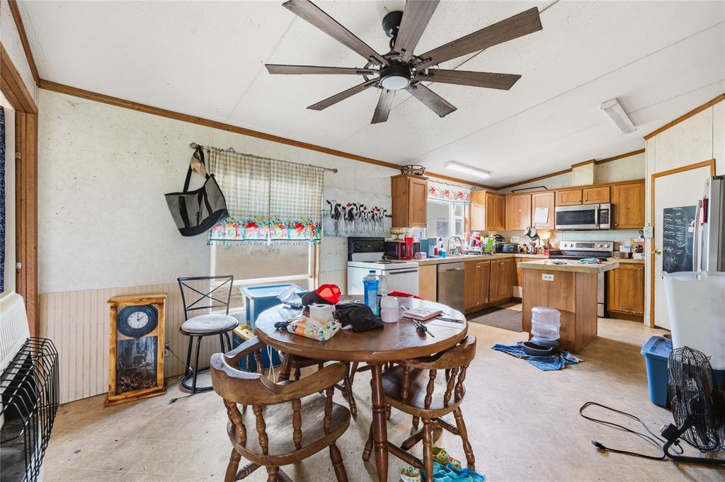 2449 East Fm 120 Denison, TX 75021 - Photo 24 of 30 a kitchen with a dining table and chairs