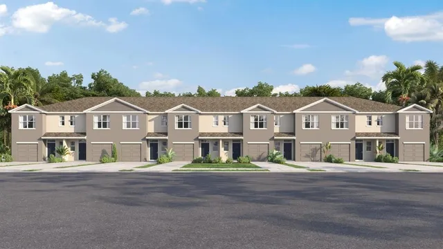 a view of a white house with a yard