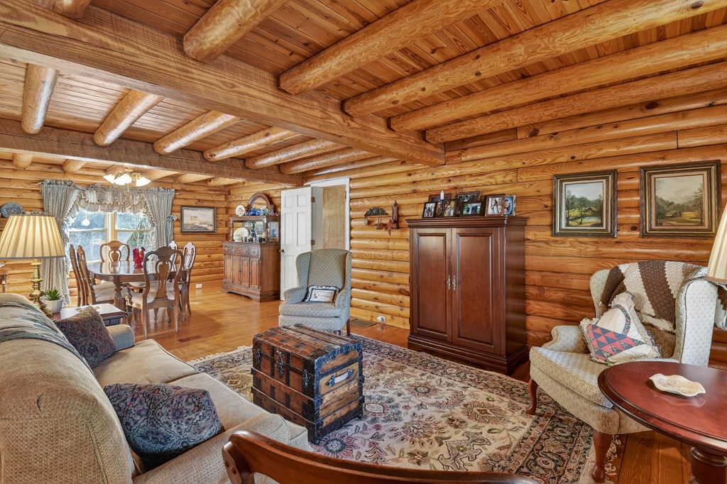 7233 Shakerag Road Ellijay, GA 30540 - Photo 11 of 117 a living room with furniture and a wooden floor