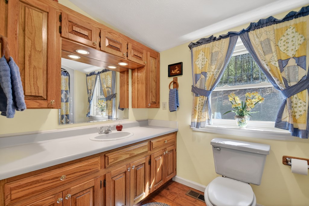 7233 Shakerag Road Ellijay, GA 30540 - Photo 16 of 117 a bathroom with a granite countertop sink mirror and a large window