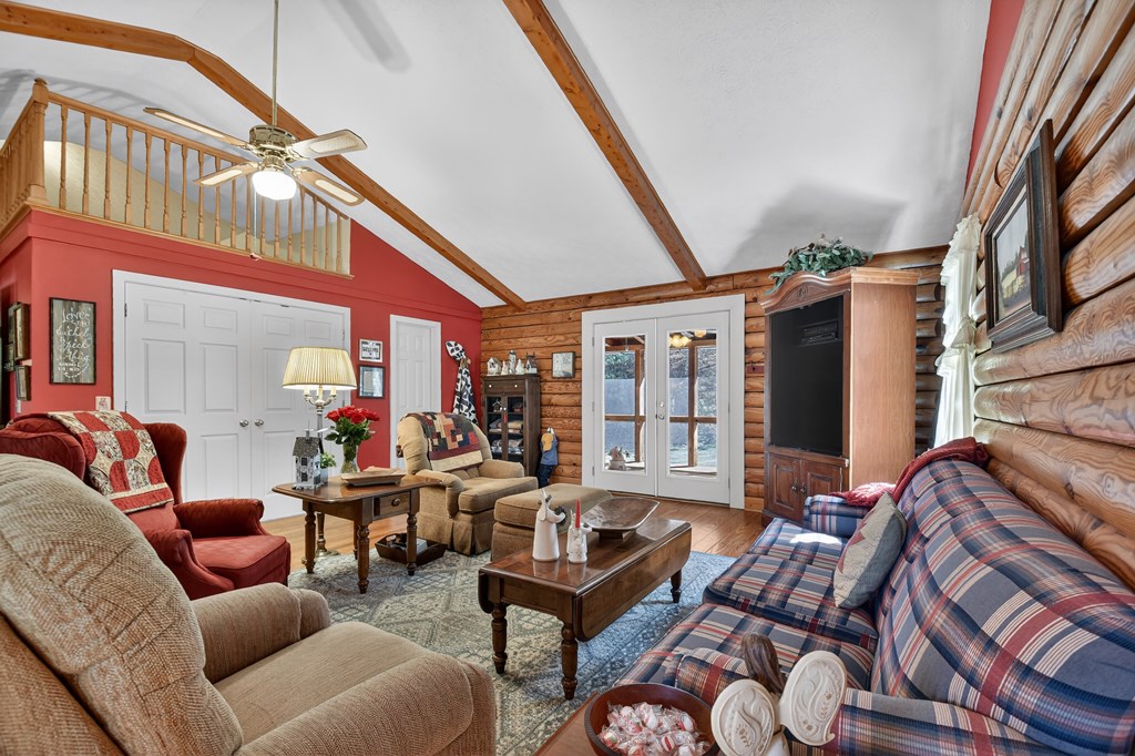 7233 Shakerag Road Ellijay, GA 30540 - Photo 25 of 117 a living room with furniture a fireplace and a large window