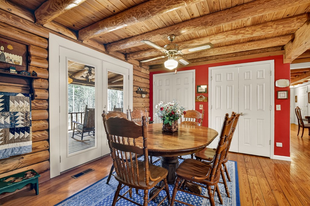 7233 Shakerag Road Ellijay, GA 30540 - Photo 29 of 117 a view of a dining room with furniture and wooden floor