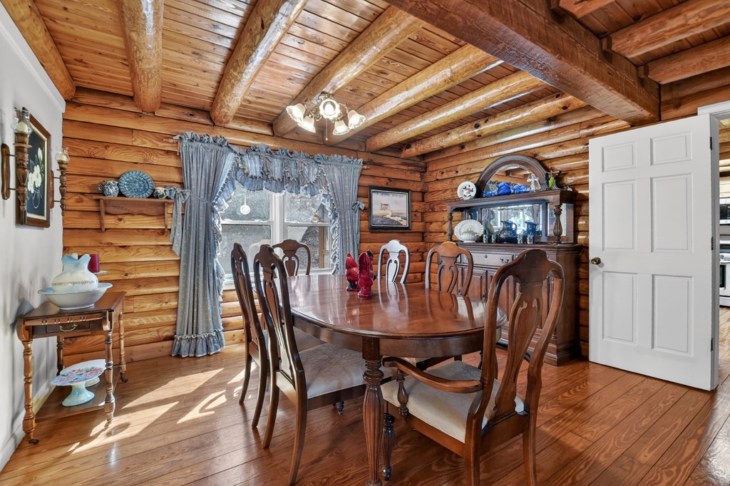 7233 Shakerag Road Ellijay, GA 30540 - Photo 40 of 117 a view of a dining room with furniture and wooden floor