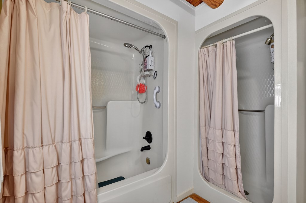 7233 Shakerag Road Ellijay, GA 30540 - Photo 45 of 117 a bathroom with a bathtub and a shower