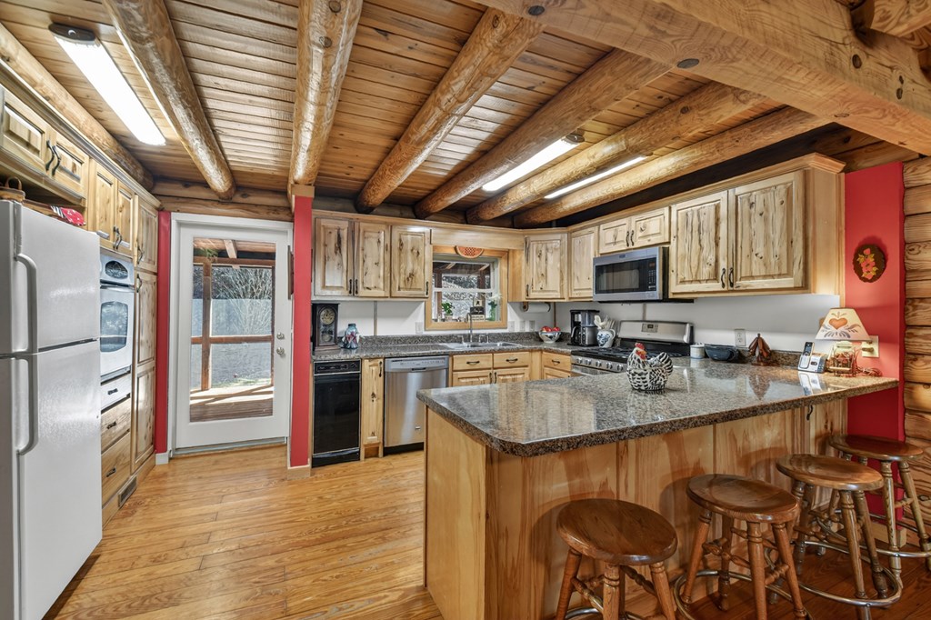 7233 Shakerag Road Ellijay, GA 30540 - Photo 69 of 117 a kitchen with stainless steel appliances granite countertop a sink a stove and a refrigerator