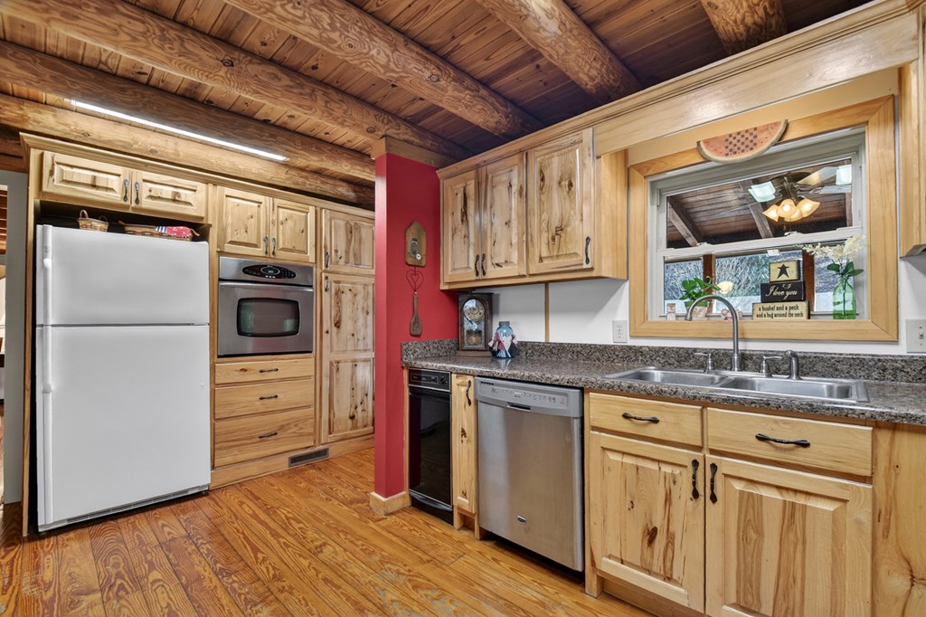 7233 Shakerag Road Ellijay, GA 30540 - Photo 71 of 117 a kitchen with stainless steel appliances granite countertop a stove and a refrigerator