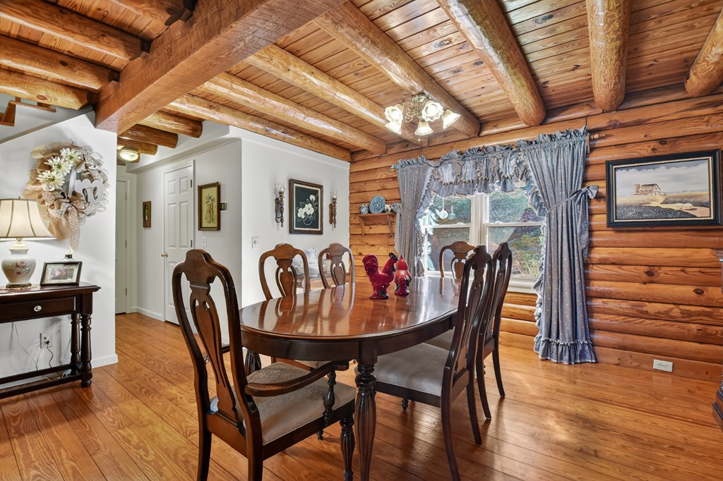 7233 Shakerag Road Ellijay, GA 30540 - Photo 74 of 117 a dining room with furniture and wooden floor