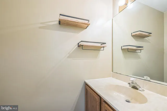 a bathroom with a sink vanity and mirror