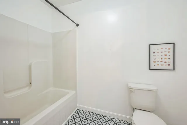 a bathroom with a toilet and a tub