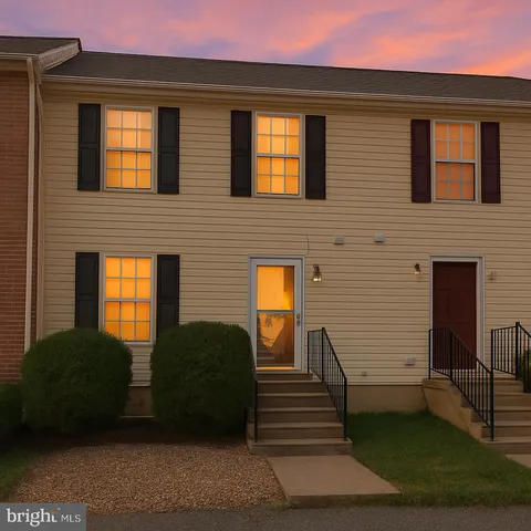 a view of a house with a large window and brick walls