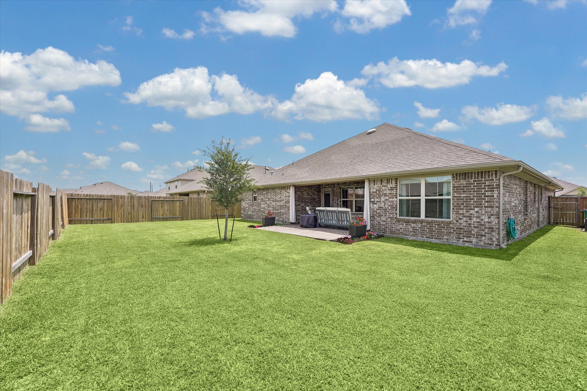 10227 Whitney Reach Drive Rosharon, TX 77583 - Photo 4 of 28 Expansive backyard with a spacious paved patio, perfect for entertaining. Enjoy the ideal north-facing orientation of this backyard.
