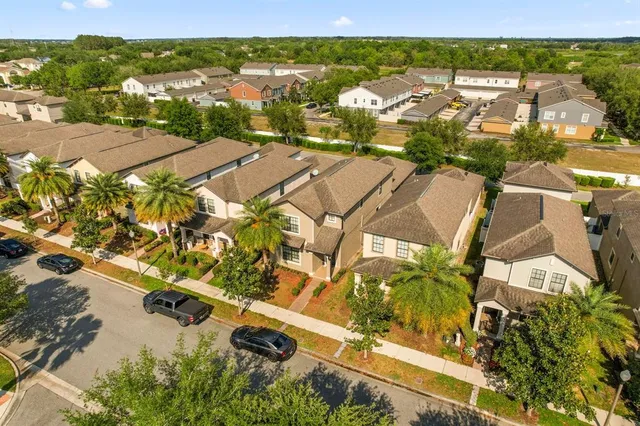 an aerial view of residential houses with outdoor space