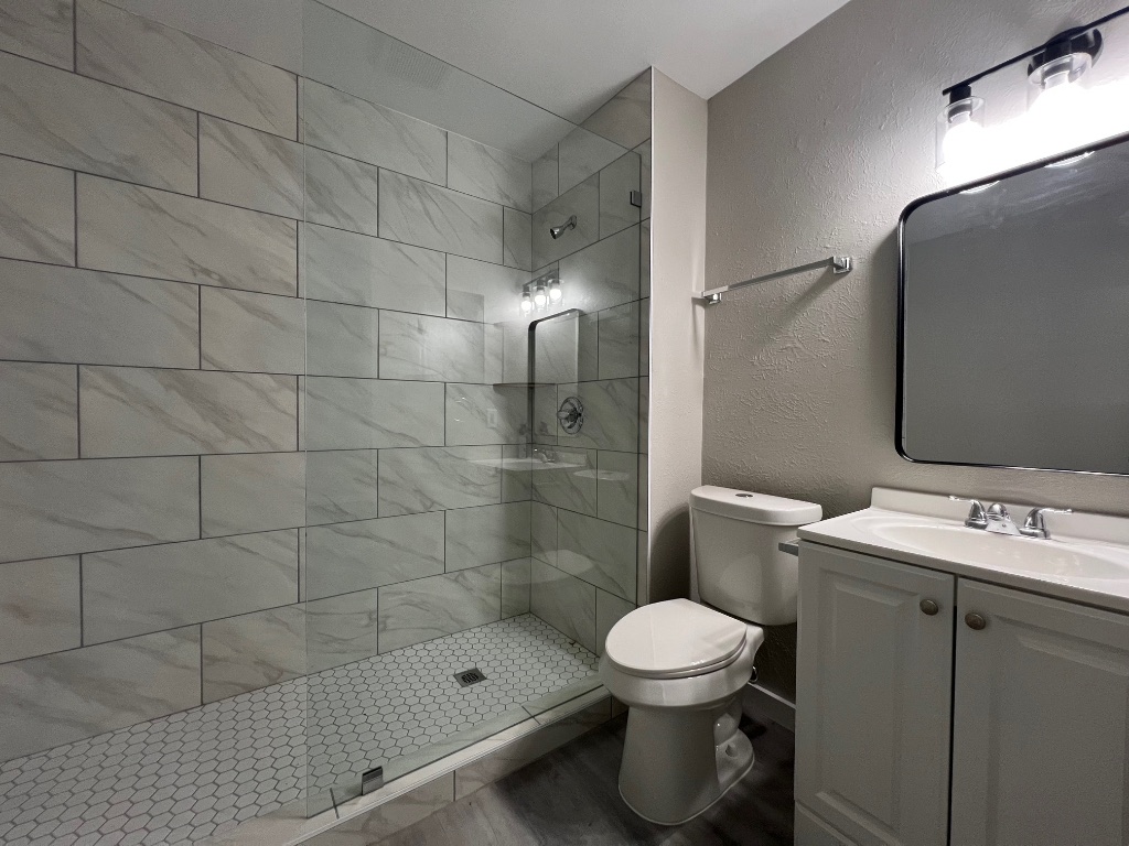 10510 Little Pebble Drive, Unit B Austin, TX 78758 - Photo 11 of 15 a bathroom with a toilet sink and shower