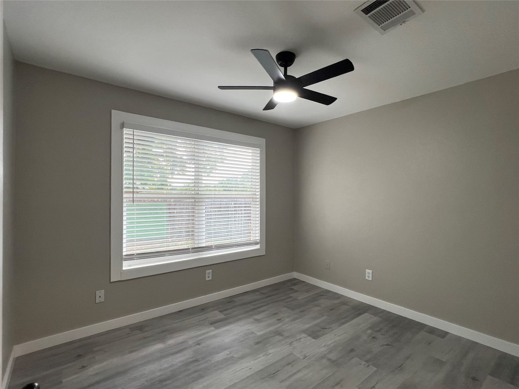 10510 Little Pebble Drive, Unit B Austin, TX 78758 - Photo 12 of 15 a view of an empty room with wooden floor and a window
