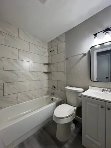 a bathroom with a toilet a sink and bathtub