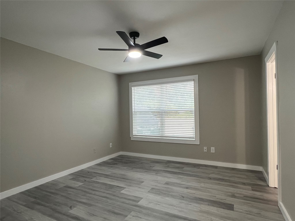 10510 Little Pebble Drive, Unit B Austin, TX 78758 - Photo 10 of 15 a view of an empty room with wooden floor and a window