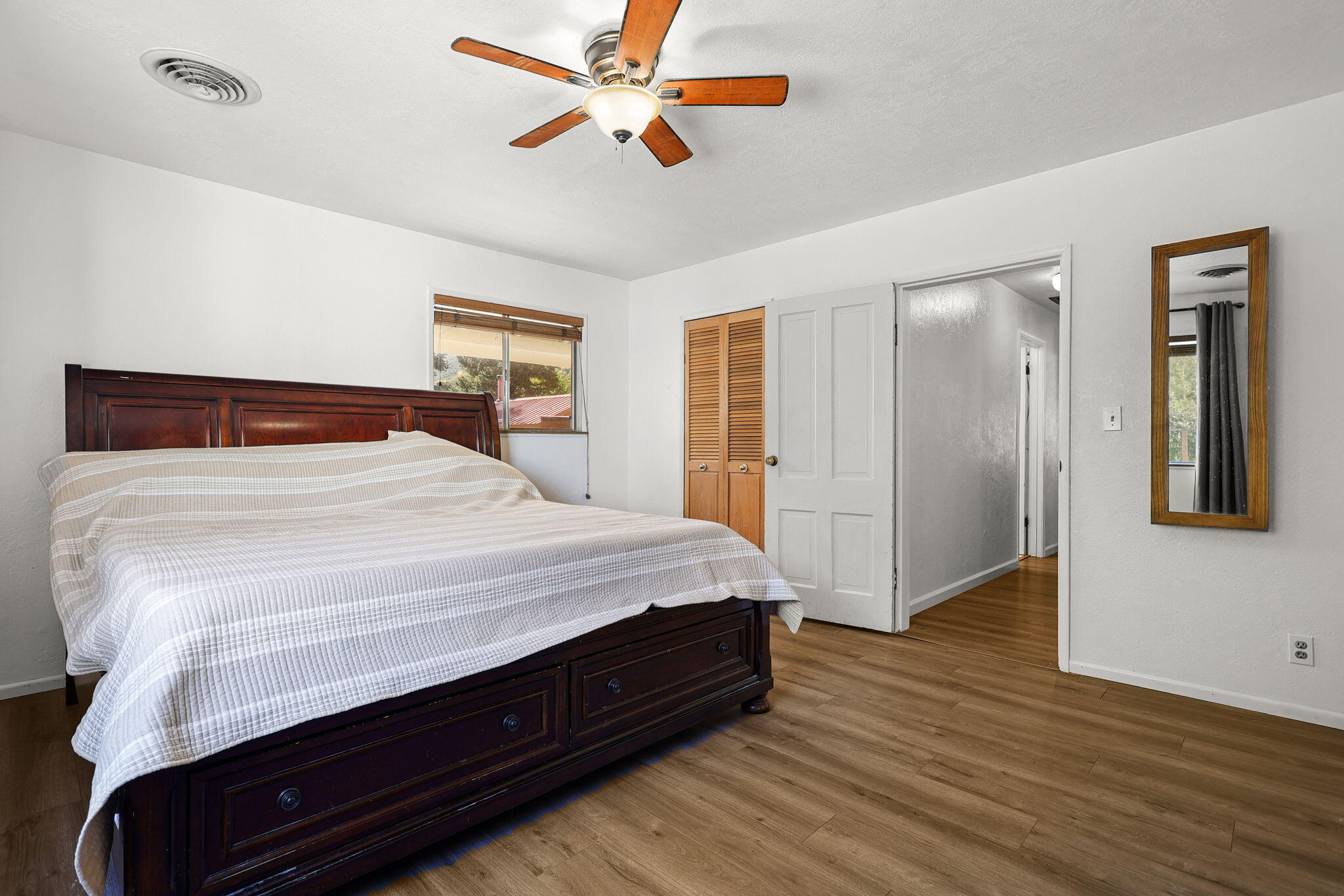 14207 Main Street French Gulch, CA 96033 - Photo 13 of 38 a bedroom with a bed and a chandelier